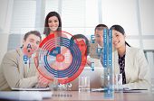 stock photo of meeting  - Smiling business workers looking at chart interface in a meeting - JPG 