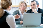stock photo of meeting  - mid adult couple meeting with financial planner or advisor - JPG 