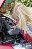 foto of pressure  - a young woman in her car after filling oil - JPG 
