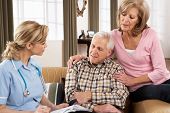 pic of health  - Senior Couple Talking To Health Visitor At Home - JPG 