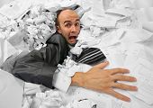 image of businessmen  - Businessman sinking in heap of documents and asking for help - JPG 