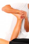 stock photo of sports  - A picture of a physio therapist trying to fix the leg over white background - JPG 