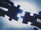 pic of puzzle  - hands trying to fit two puzzle pieces together - JPG 