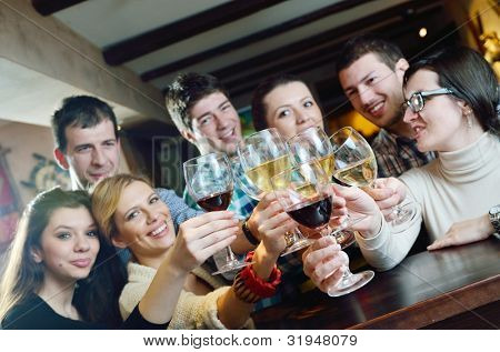 Picture or Photo of Group of happy young people drink wine  at party disco restaurant