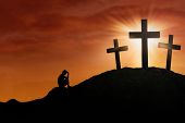 picture of religion  - Silhouette of a man repent at the Cross on sunset background - JPG 