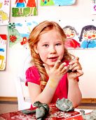 stock photo of preschool  - Child girl with clay in play room - JPG 