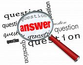 stock photo of answer  - A magnifying glass hovering over many questions to find the answer - JPG 