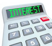 stock photo of money  - A plastic calculator displays the word Interest as you figure how the percentage interest rate you will pay on borrowed money or the money you will make on investments - JPG 