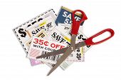 image of investment  - Horizontal shot of many coupons with a pair of red handled scissors - JPG 