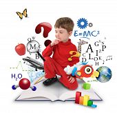 stock photo of boy  - A young boy is sitting on a big with different science - JPG 
