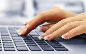 stock photo of type  - Female hands typing on laptot - JPG 