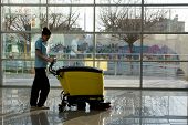 picture of industrial  - A worker is cleaning the floor with machine - JPG 