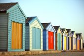 stock photo of hut  - Brightly painted beach huts of houses in a row - JPG 