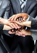 foto of teamwork  - diverse group of workers with their hands together in form of teamwork - JPG 