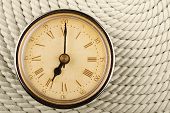 foto of tick tock  - Clock with Roman numerals on cord background - JPG 