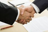 picture of handshake  - Photo of business handshake over workplace - JPG 