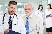 stock photo of medical doctors  - The young doctor talks to the patient - JPG 