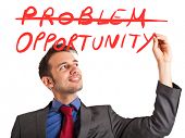 picture of possibility  - Young positive businessman writing a positive concept on the screen - JPG 