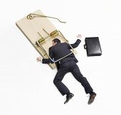 stock photo of businessmen  - Businessman trapped on mousetrap on white background - JPG 