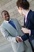 stock photo of handshake  - Two business professionals man and woman shaking hands - JPG 