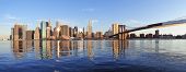 foto of bridge  - Brooklyn Bridge with lower Manhattan skyline panorama in the morning with cloud and river reflection over East River in New York City - JPG 