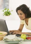 picture of woman  - Woman typing on laptop - JPG 